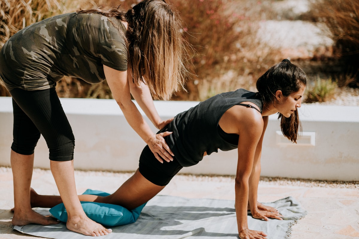 Yoga teacher demonstrating breathing technique to students in class